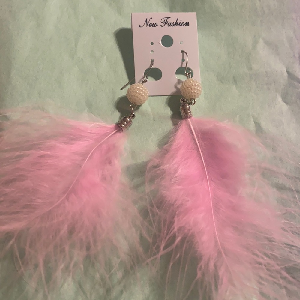 Pink feather earrings.